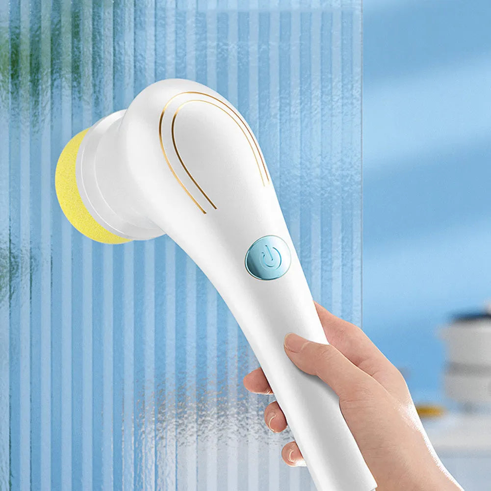 White cordless electric handheld scrubber with five attached brush heads on a kitchen counter