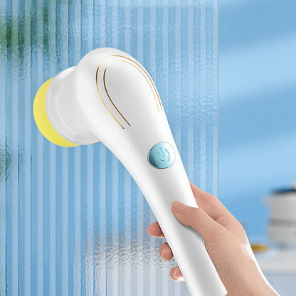 White cordless electric handheld scrubber with five attached brush heads on a kitchen counter