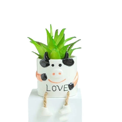 Ceramic hanging foot flowerpot with cartoon design for succulents on desktop