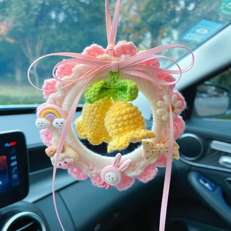 Green woven wool bell orchid car pendant hanging, showing handmade texture and fresh style.