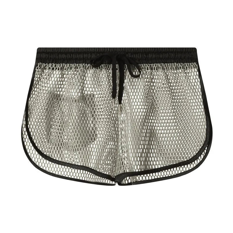 Men's solid colour loose fit polyester boxer shorts shown in black, white, grey, and red.