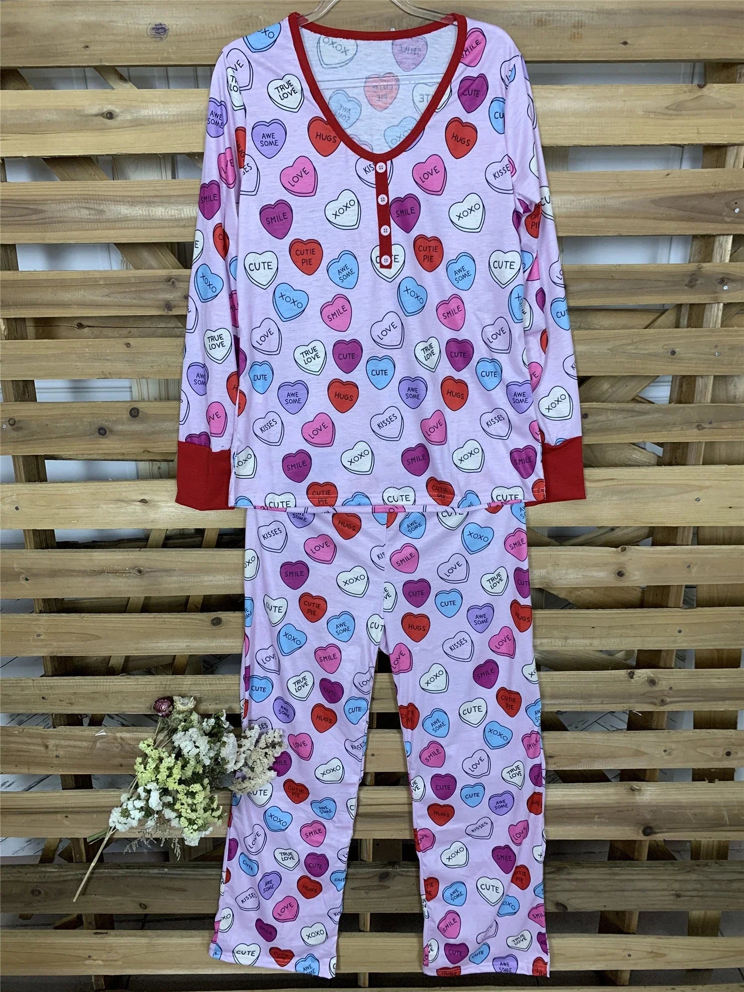 Adorable heart-printed family pajamas with long-sleeve tops and full-length bottoms in a range of sizes for children and adults.