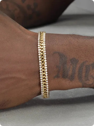 Gold-coloured titanium steel tennis bracelet with artificial gemstone inlay on a wrist.
