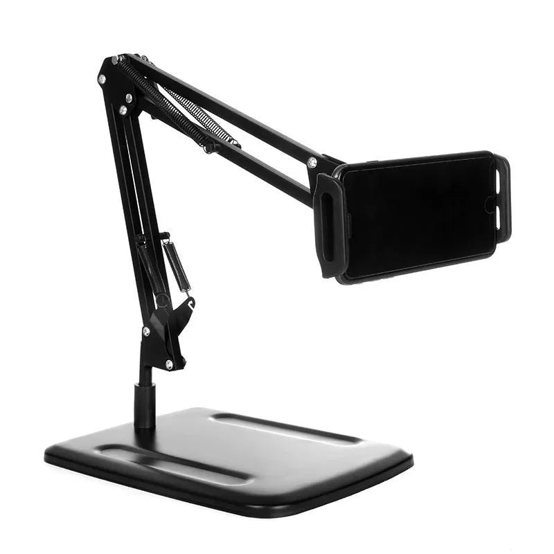 Black metal adjustable phone and tablet stand with a heavy round base on a wooden desk