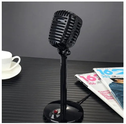 Black USB computer microphone with adjustable gooseneck and weighted silicone base stand on a desk.