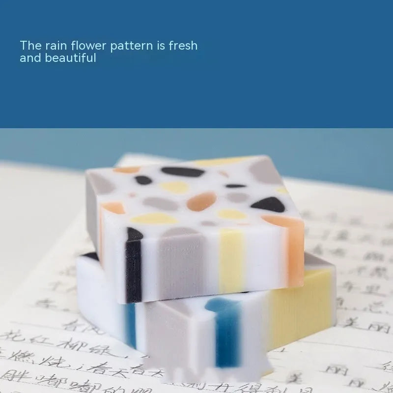 White rectangular rubber brick eraser for students on a blue background.