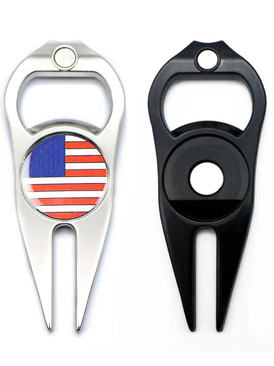 Black zinc alloy golf ball fork and bottle opener tool on a putting green.
