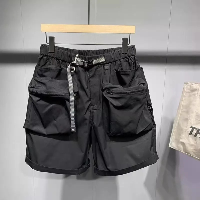 Men's black loose-fit work shorts with multiple pockets showing mid-waist design
