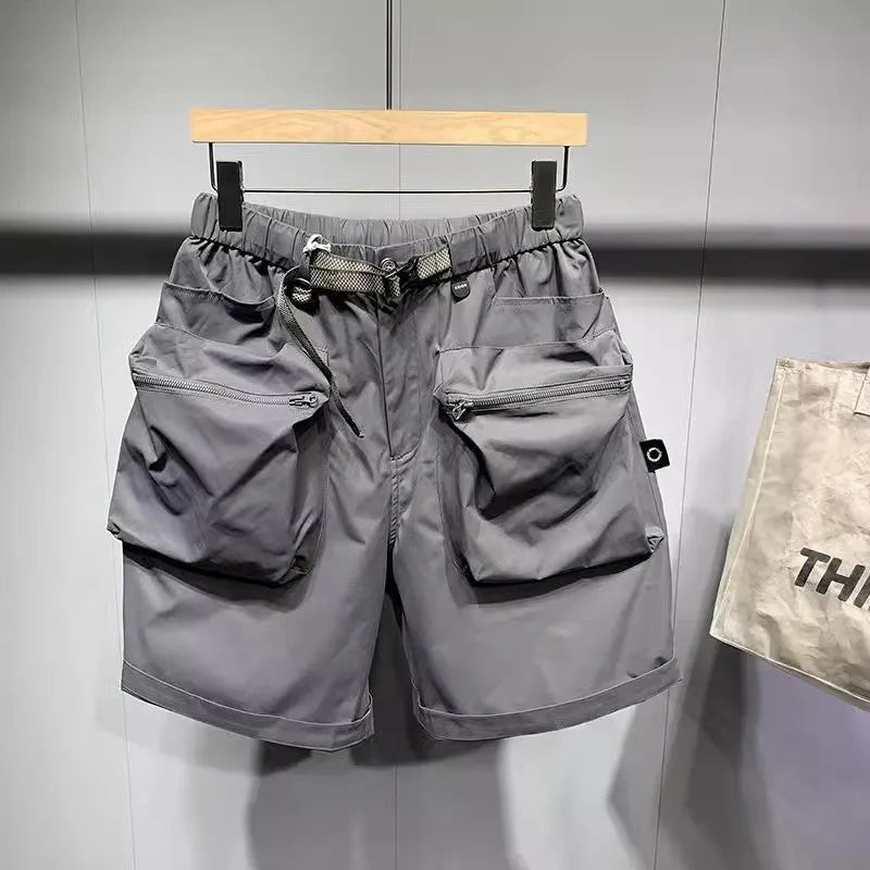 Men's black loose-fit work shorts with multiple pockets showing mid-waist design