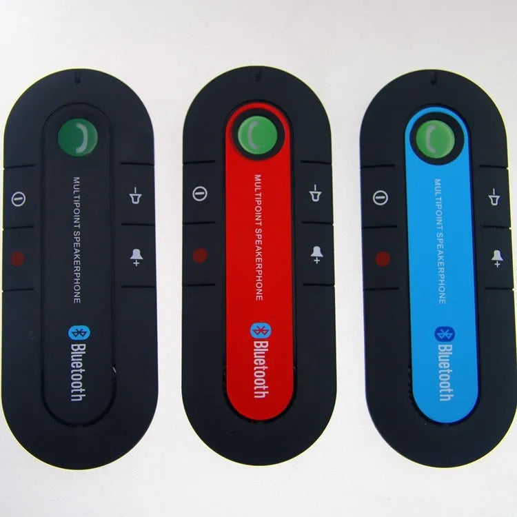 Black Bluetooth hands-free car kit mounted on a car sun visor with charger and cable.