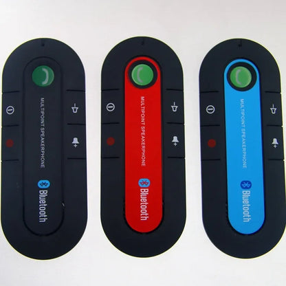 Black Bluetooth hands-free car kit mounted on a car sun visor with charger and cable.