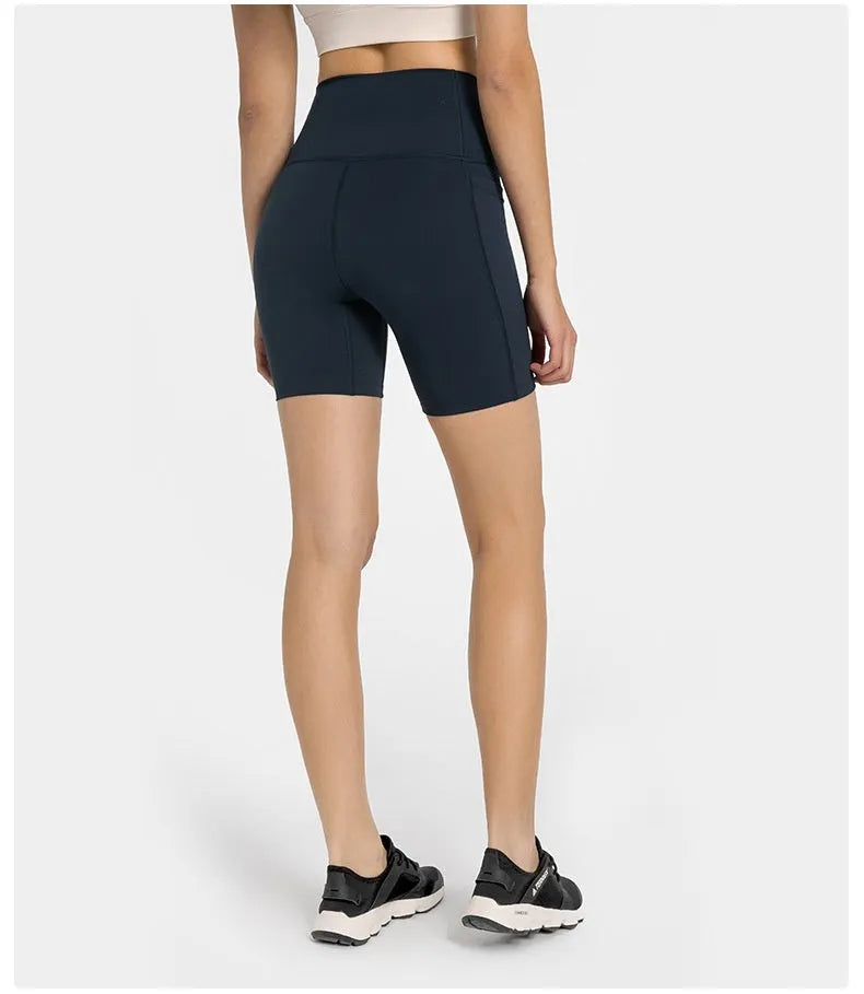 Women's tight-fitting cotton blend sports shorts in black, showing super stretch function and fifth pants length.