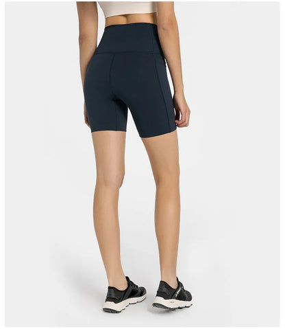 Women's tight-fitting cotton blend sports shorts in black, showing super stretch function and fifth pants length.