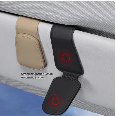 Car sunglasses holder clip with PU leather case attached to a sun visor.