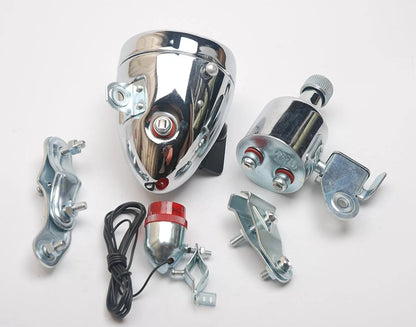 Silver dynamo-powered bicycle light set with generator unit for friction drive on wheel.