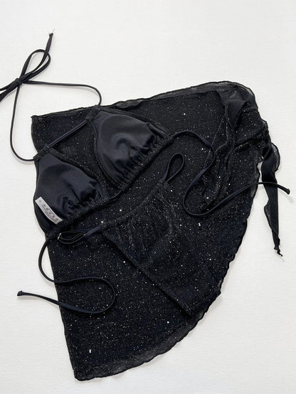 Black three-piece fission style swimsuit bikini set with top and shorts on a mannequin.