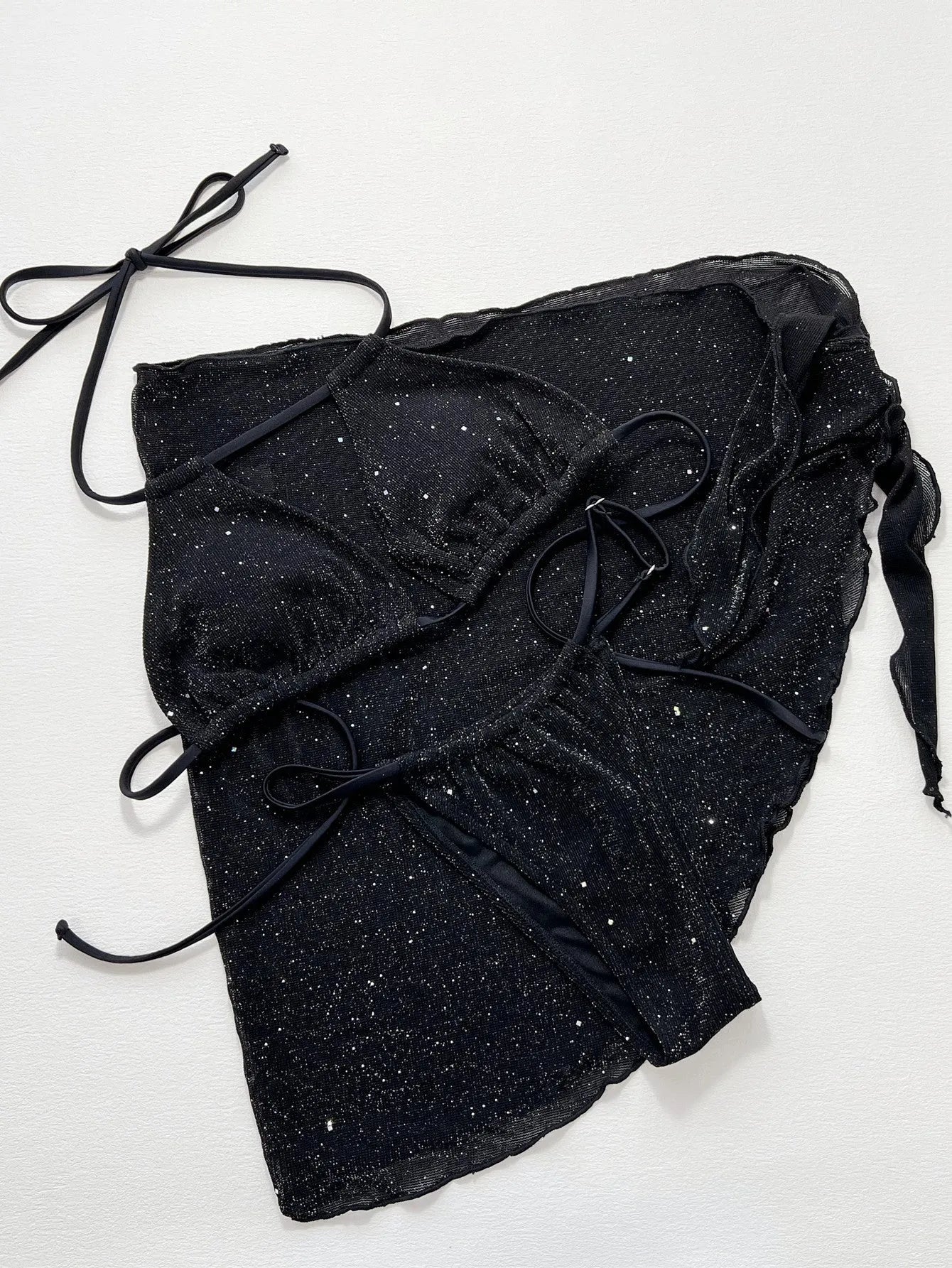 Black three-piece fission style swimsuit bikini set with top and shorts on a mannequin.