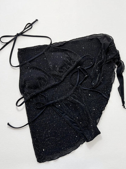 Black three-piece fission style swimsuit bikini set with top and shorts on a mannequin.