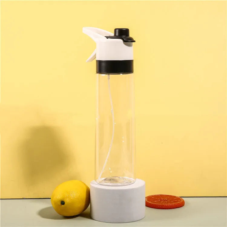 White spray water bottle with black leakproof lid and handle strap on a table