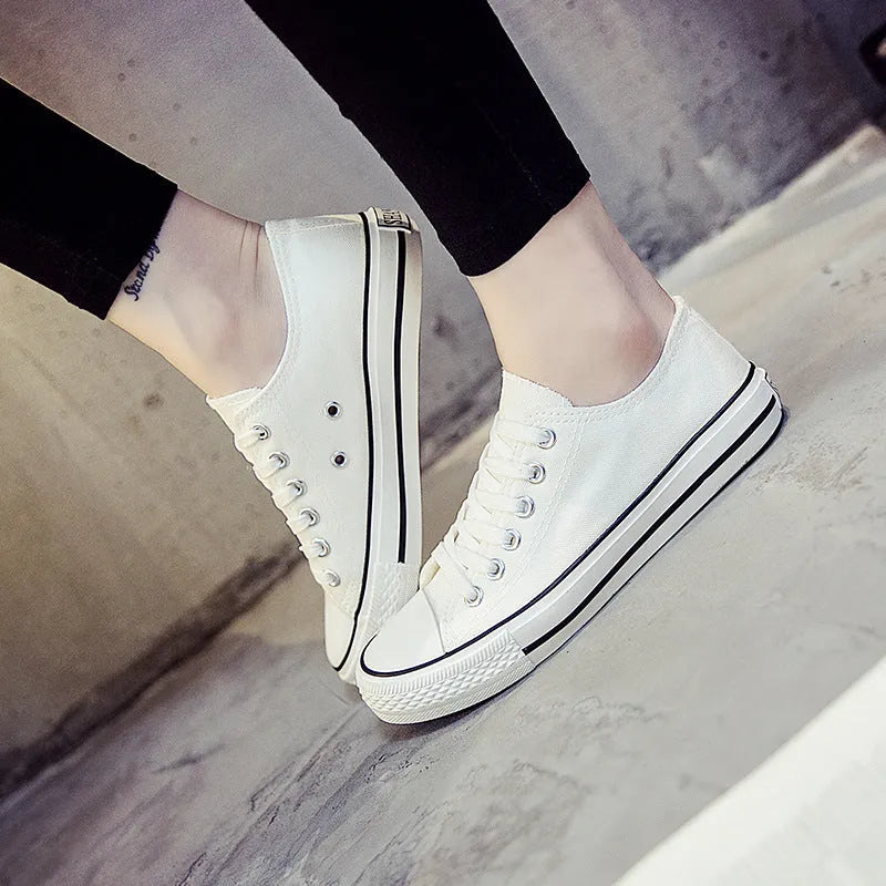 Women's solid-colour canvas casual shoes in black, shown from the side.