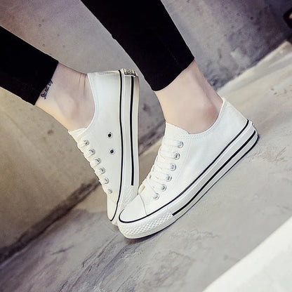 Women's solid-colour canvas casual shoes in black, shown from the side.