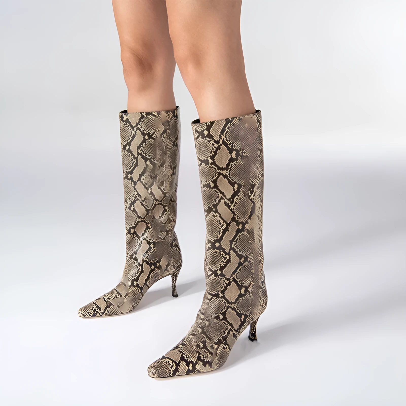 A pair of women's black square-toe cowboy boots made from microfiber leather.