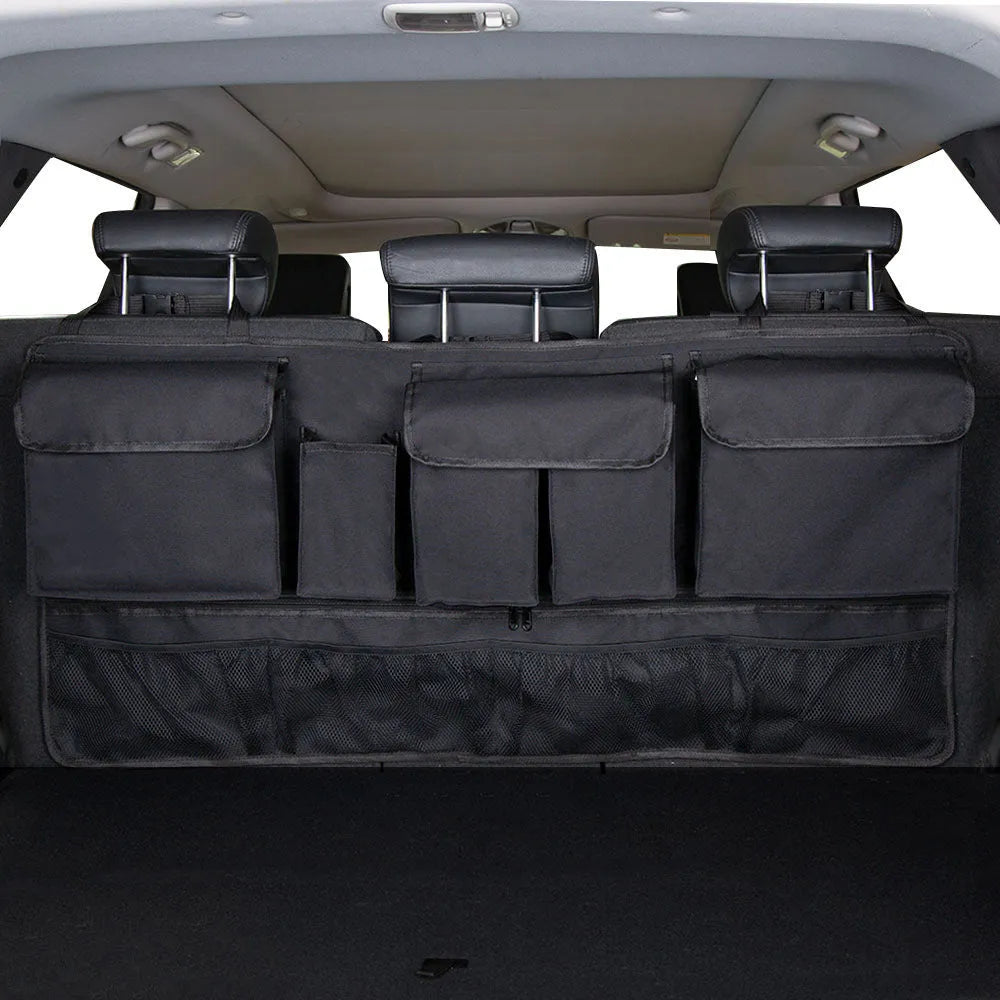 Black car hanging storage bag made of waterproof Oxford cloth with a handle, shown hanging in a vehicle boot.