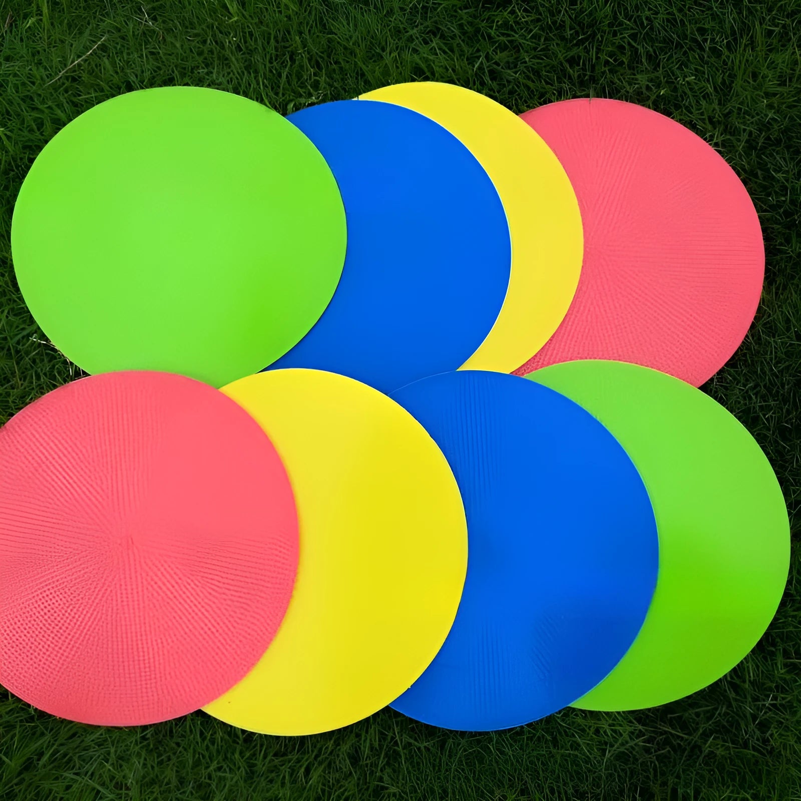 Soft yellow TPE football training landmark pad disc on grass, 23cm diameter.