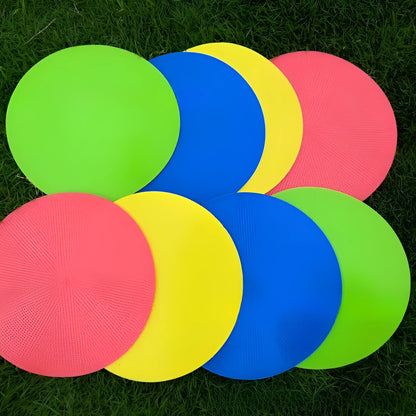 Soft yellow TPE football training landmark pad disc on grass, 23cm diameter.