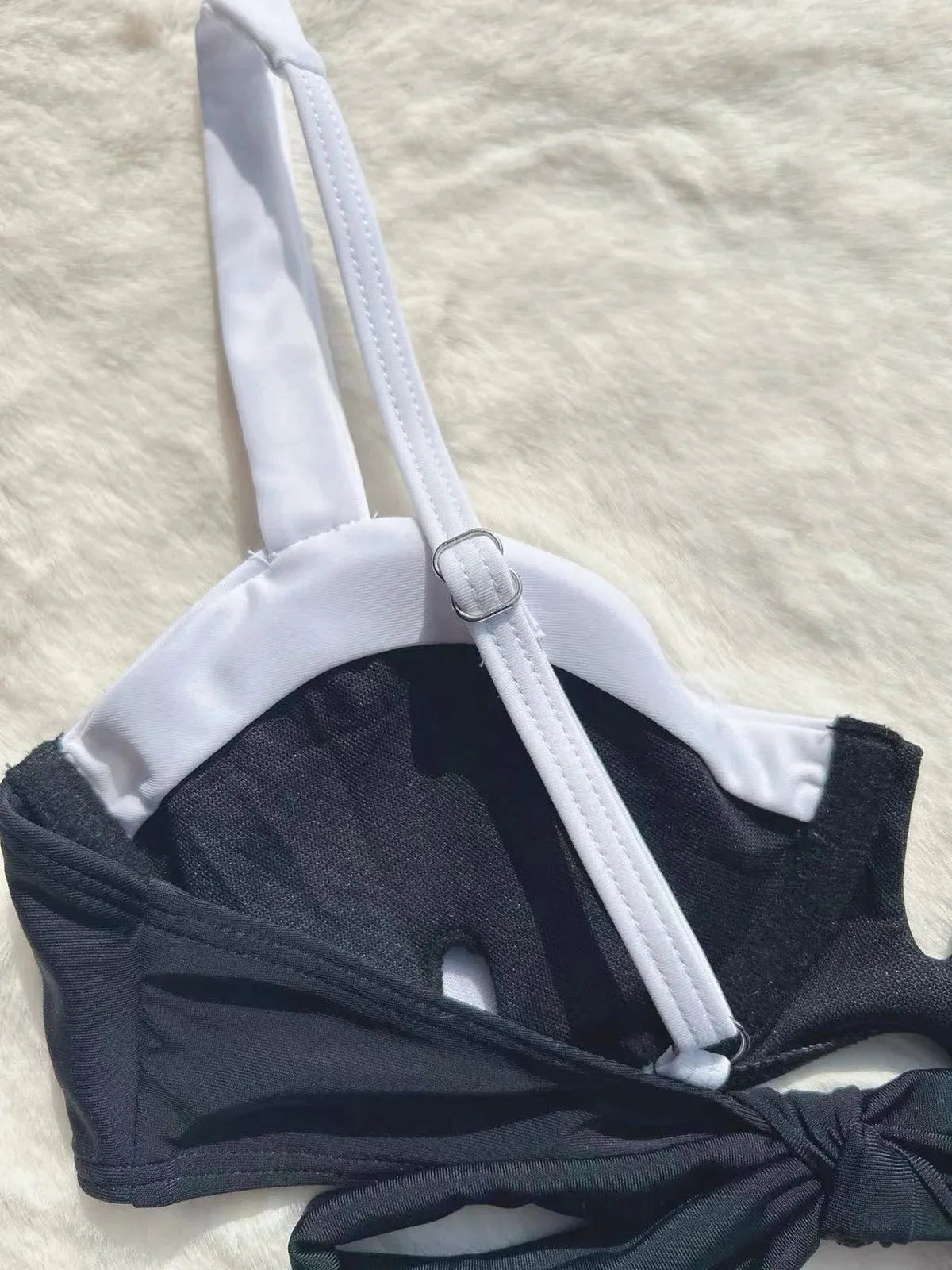 Women's black low waist bikini swimsuit with stitching detail and split brief design.