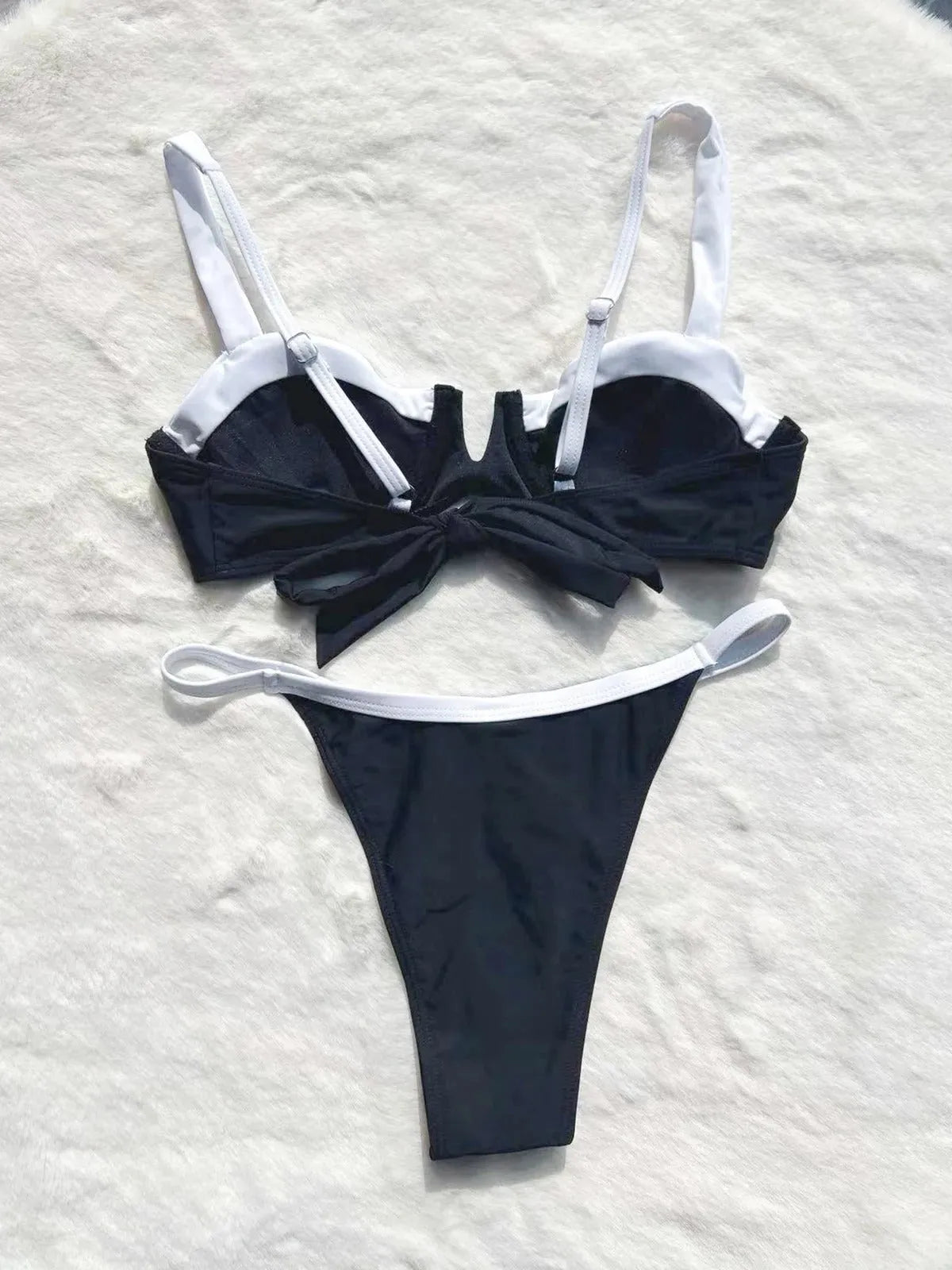 Women's black low waist bikini swimsuit with stitching detail and split brief design.