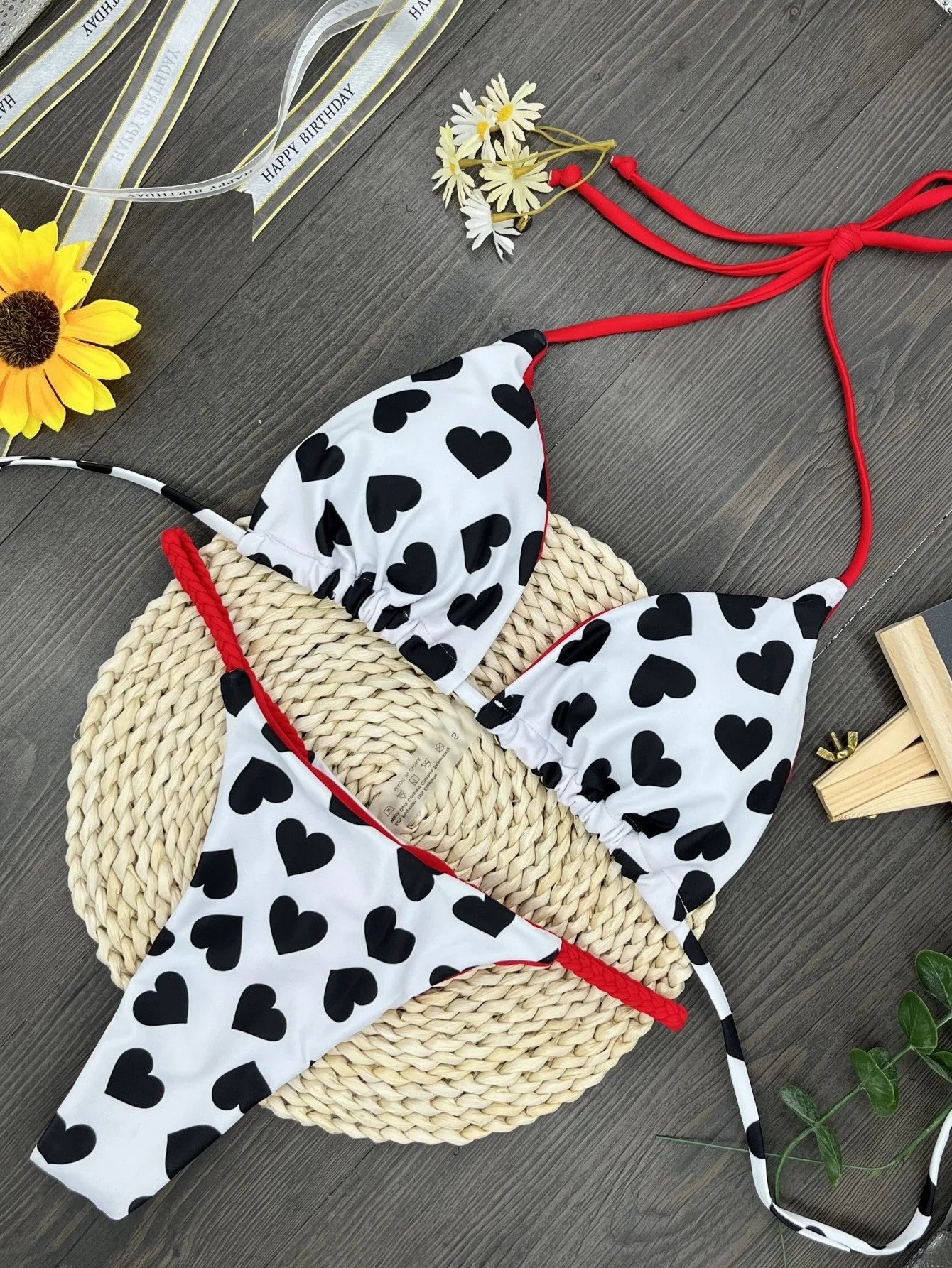 Heart print women's backless one-piece swimsuit with split sides on a mannequin