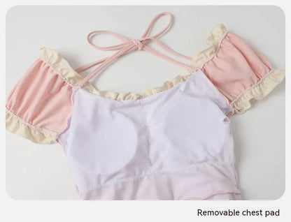 Pink women's conservative one-piece swimsuit with Siamese design on a hanger