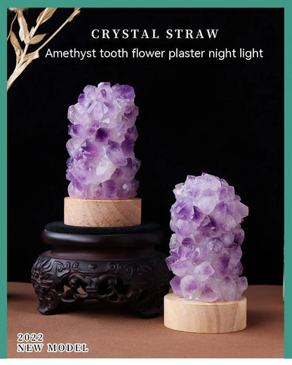 Mini USB night light glowing inside a natural amethyst crystal vug geode on a dark surface.