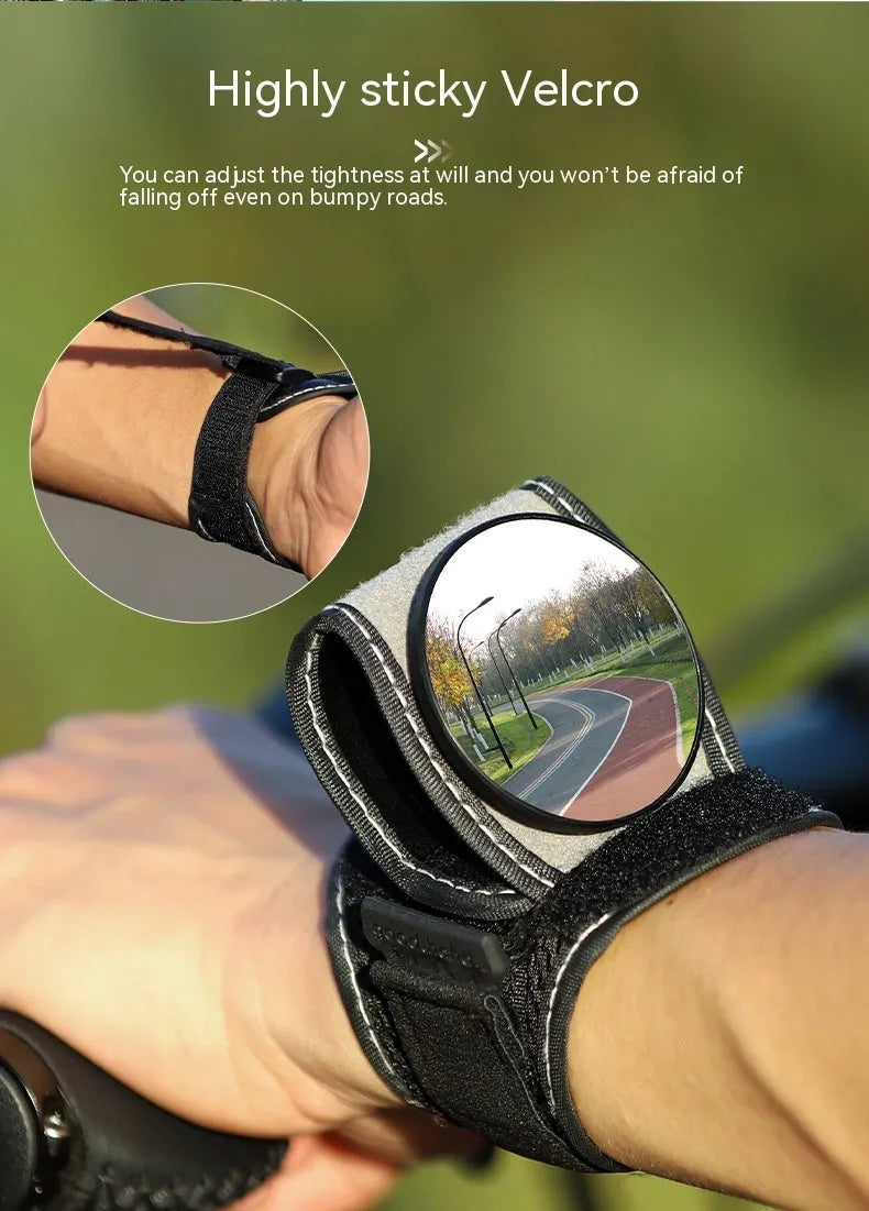 Black nylon bicycle rear-view mirror mounted on a cyclist's wrist.