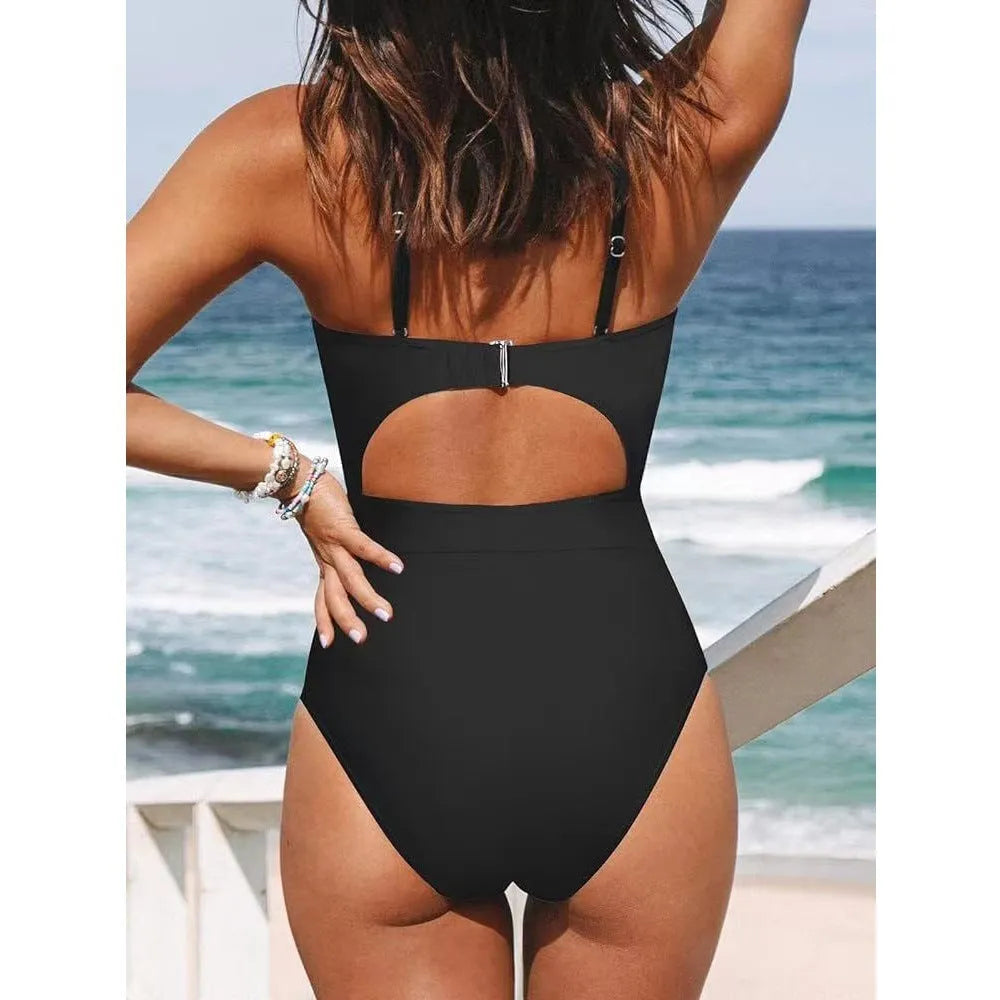 Women's black cross-back one-piece swimsuit with backless design on mannequin
