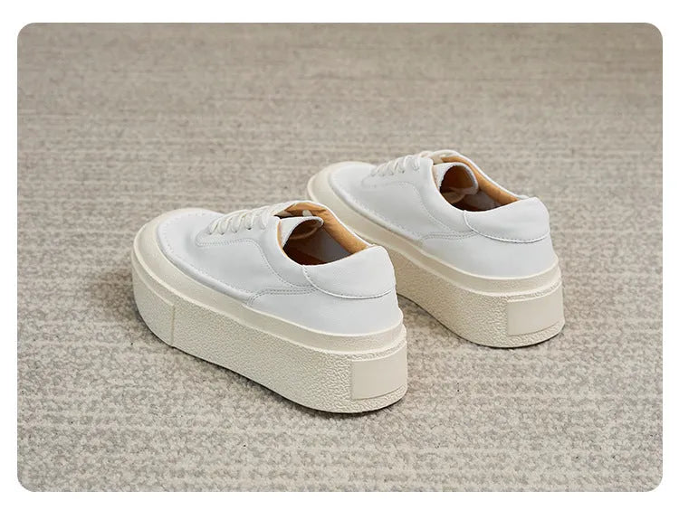 Women's black platform casual shoes with round toe and tied laces on a rubber sole.