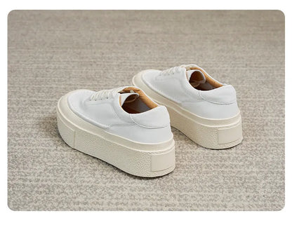 Women's black platform casual shoes with round toe and tied laces on a rubber sole.