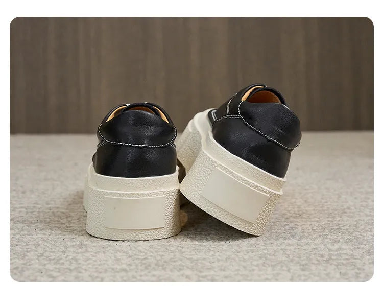 Women's black platform casual shoes with round toe and tied laces on a rubber sole.
