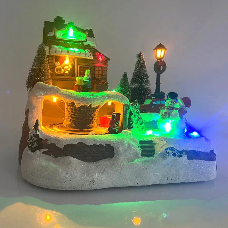 Illuminated Christmas village house with rotating Santa, Snowman, and Christmas tree decorations and playing holiday music