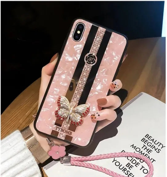 Decorative acrylic iPhone case featuring a diamond butterfly design with a mirror, shown in rose colour.