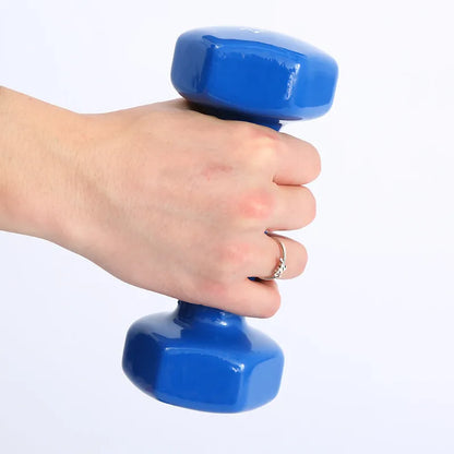 Set of bright coloured plastic-coated fitness dumbbells in 0.5kg, 1kg, and 1.5kg weights on a floor.
