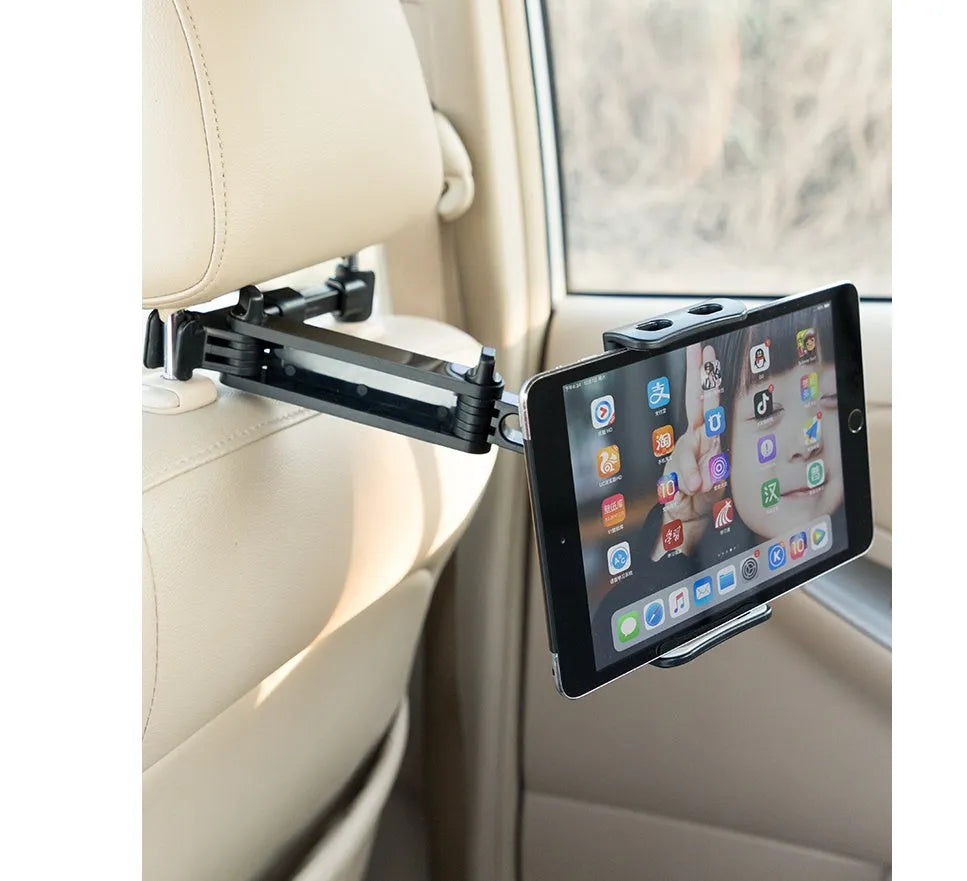 Black car phone holder mounted on vehicle rear seat with tablet secured in snap-in bracket