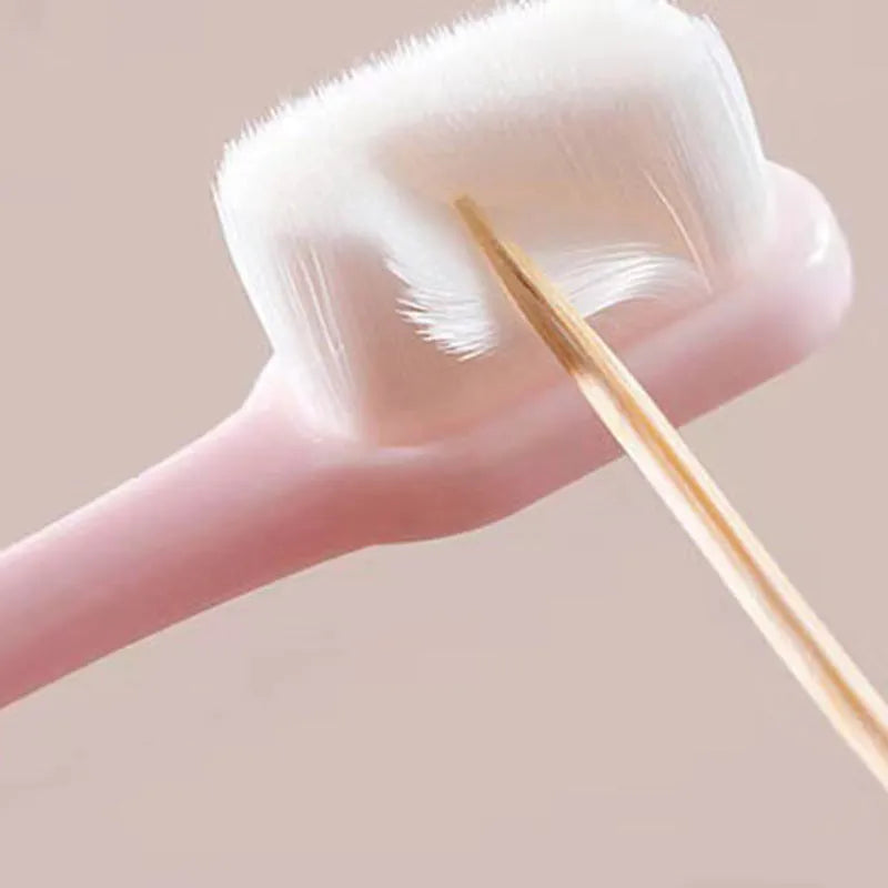 Micron soft toothbrush with coloured handles and different bristle styles including flat head and wavy designs