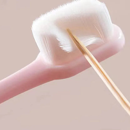 Micron soft toothbrush with coloured handles and different bristle styles including flat head and wavy designs