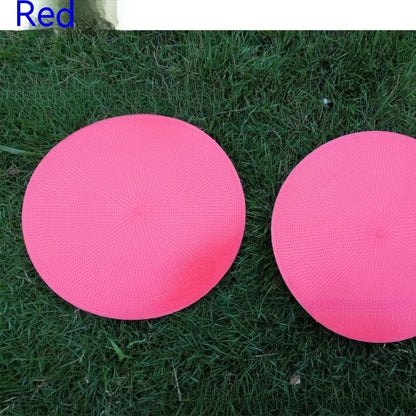 Soft yellow TPE football training landmark pad disc on grass, 23cm diameter.