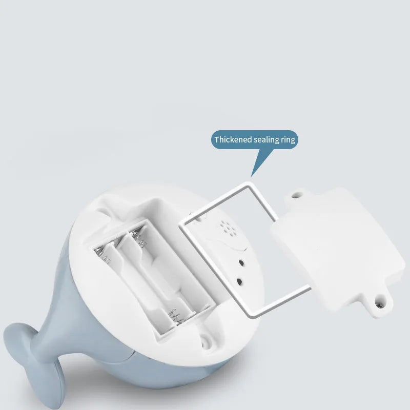 Grey or white electric whale bath toy spraying water with LED lights on a base.