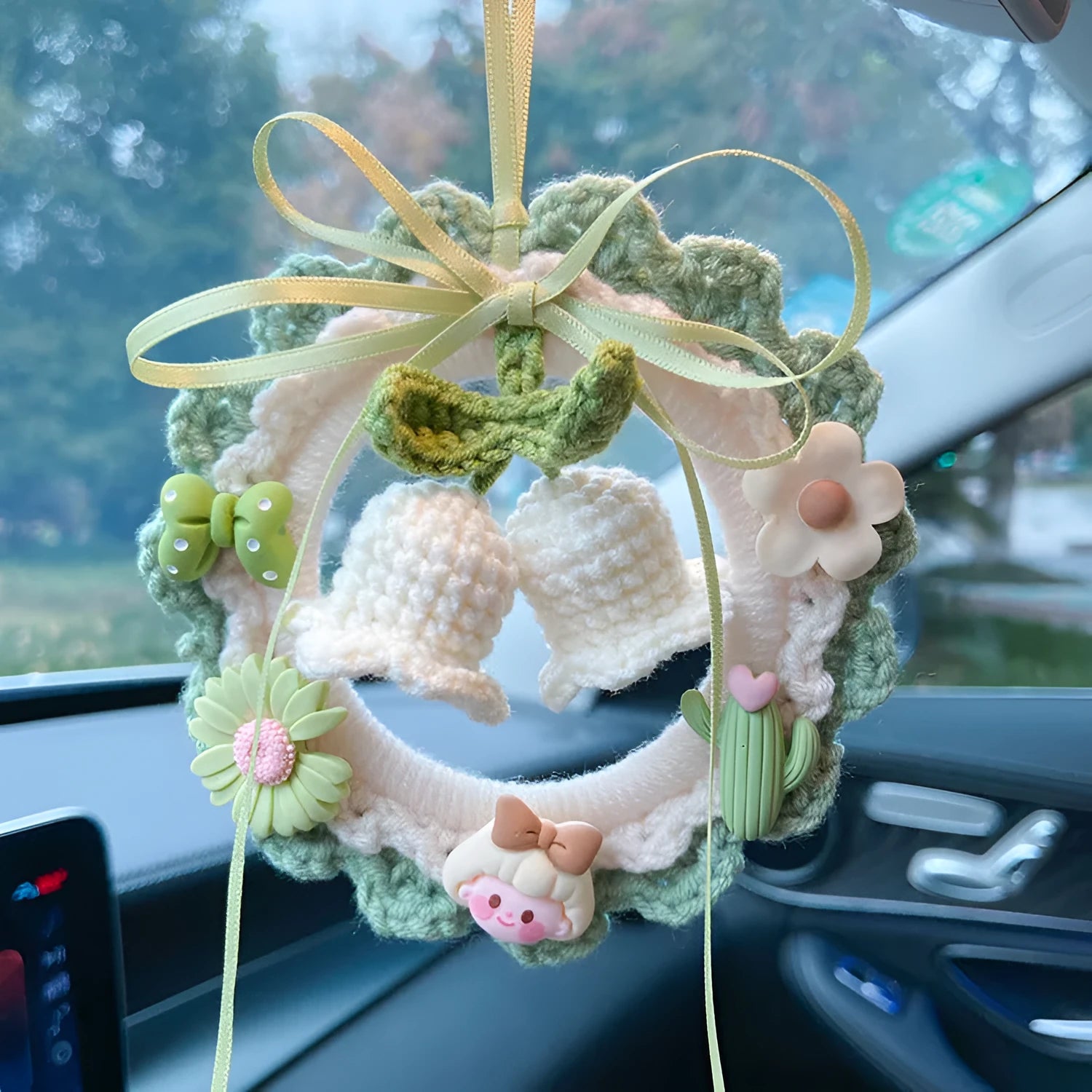 Green woven wool bell orchid car pendant hanging, showing handmade texture and fresh style.