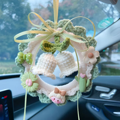 Green woven wool bell orchid car pendant hanging, showing handmade texture and fresh style.