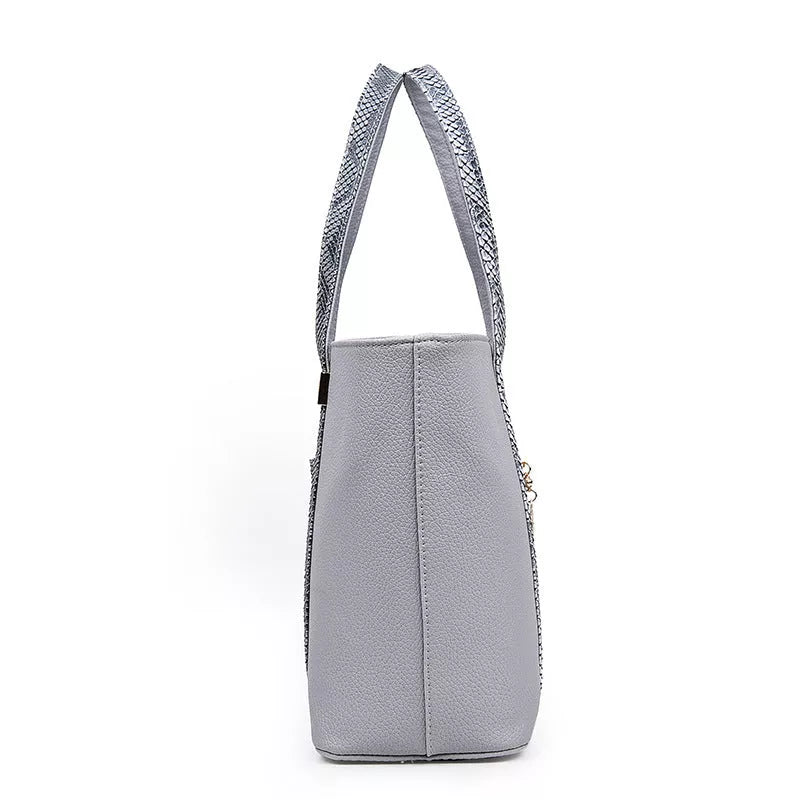 Women's shoulder bag with zipper closure and multiple pockets in light grey, black, off-white, and rose red